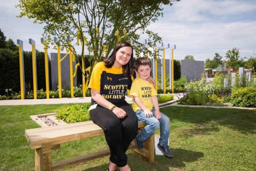 Jack on a sunlit bench with Nikki, Scotty's founder