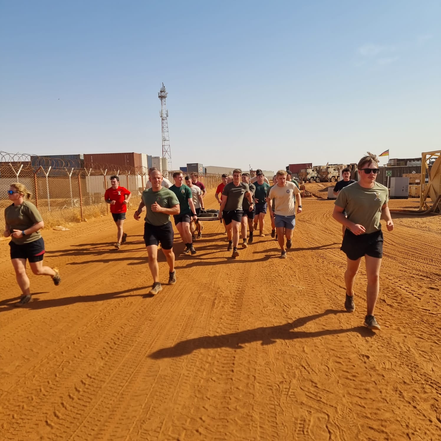 David and his colleagues in the Royal Regiment of Scotland running with a 50kg stretcher