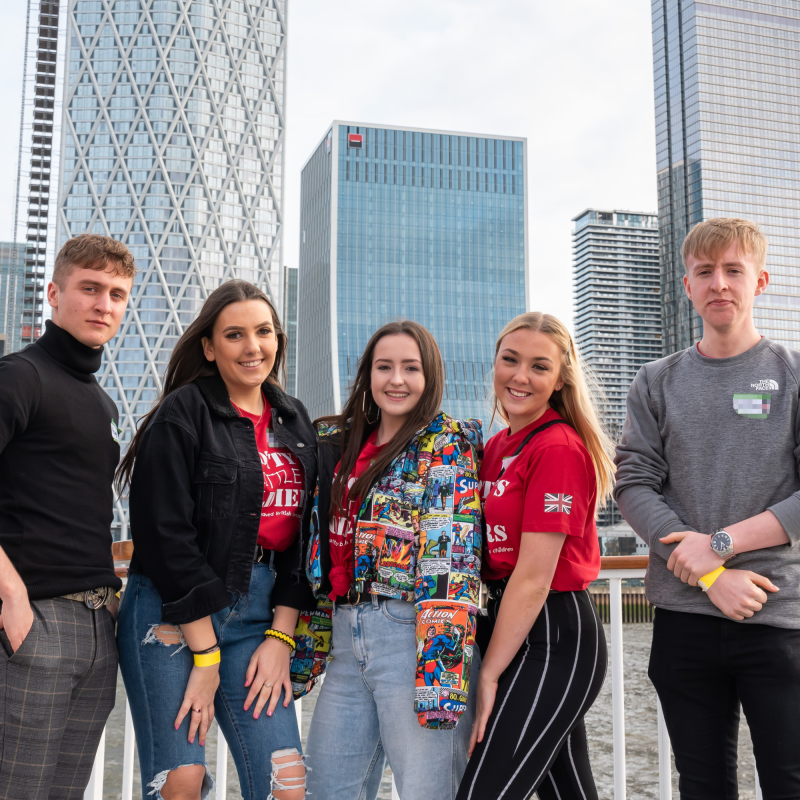 group of five bereaved British Forces young people at Scotty's Christmas Party on a boat on the Thames in London