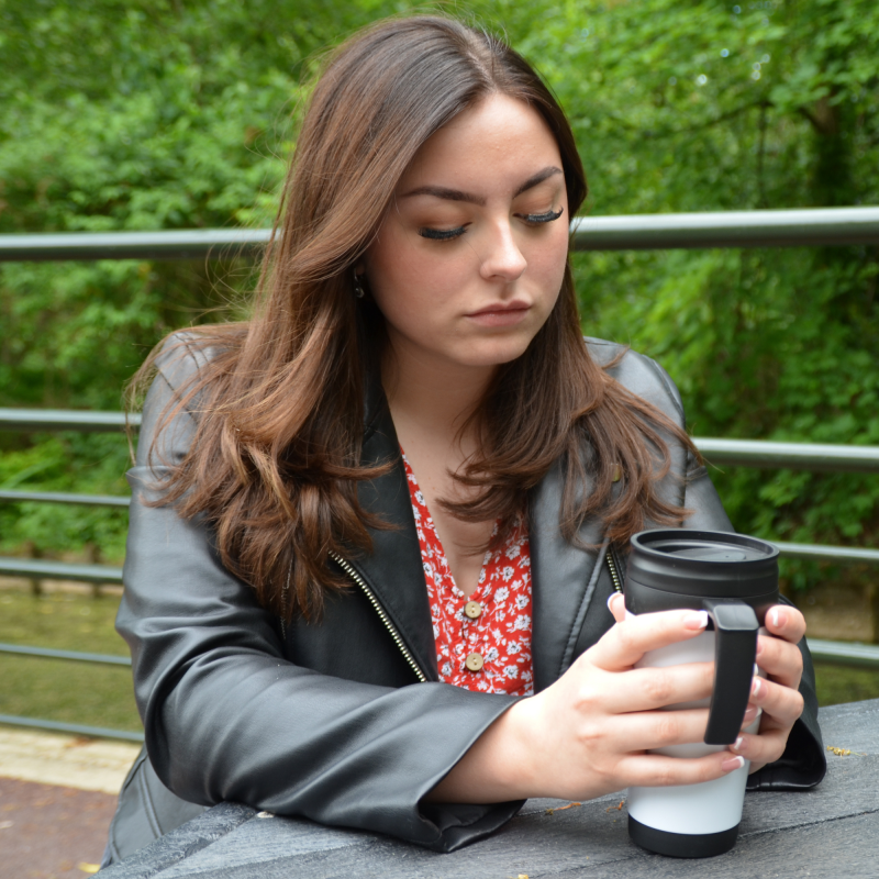 Teenage girl looking sad, holding a coffee cup. Bereaved Young Person, Springboarder Scotty's Little Soldiers